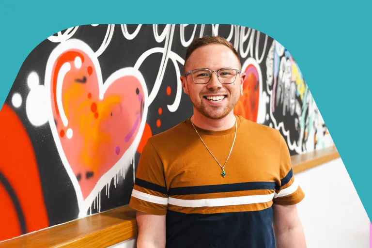 A member of the Aviva comms team standing in front of a mural