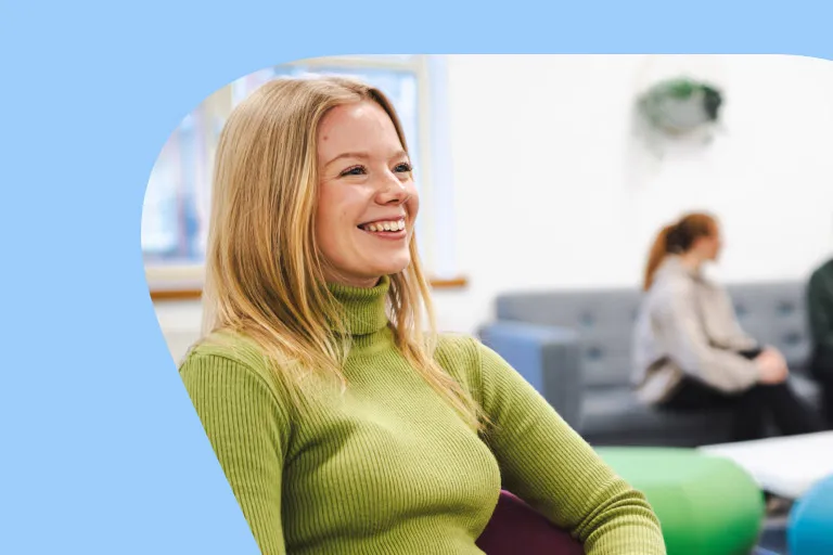 A woman smiling in an Aviva breakout space