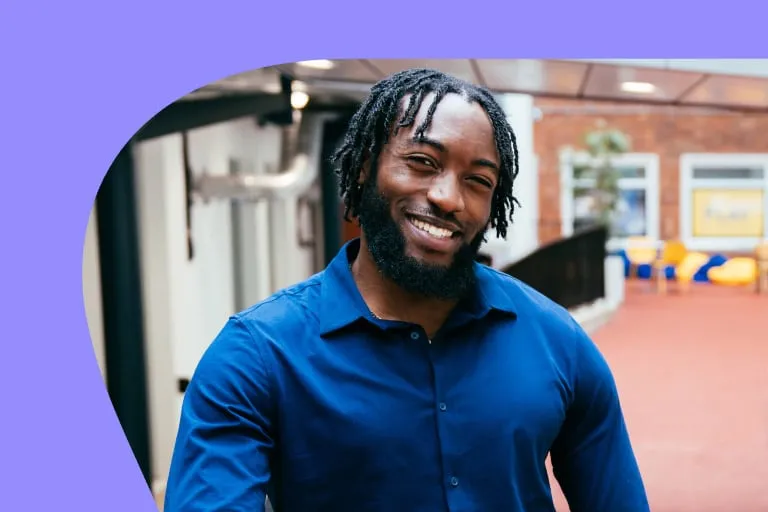 Smiling Black Man With Dreadlocks Wearing Blue Button up Shirt