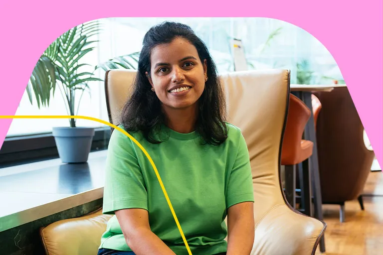 A female tech employee sits in an Aviva breakout space