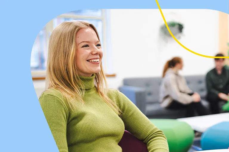 A woman smiling in an Aviva breakout space