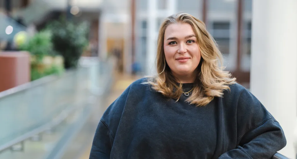 A professional woman standing in an Aviva office