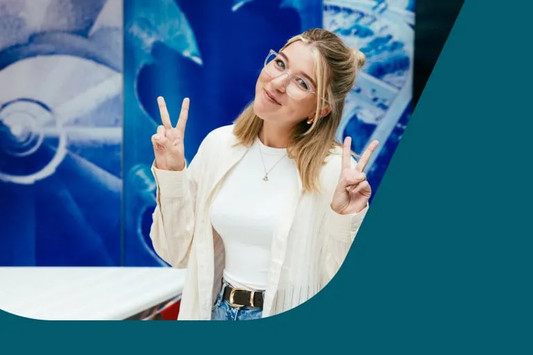 Young Woman With Glasses Head Tilted Giving Peace Sign With Both Hands